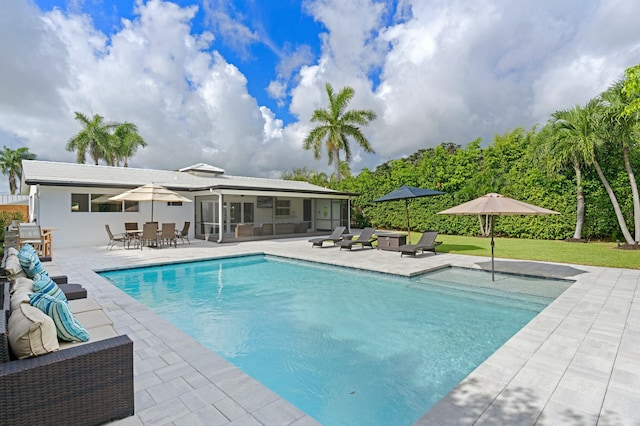 pool featuring outdoor dining area, a patio, and a sunroom