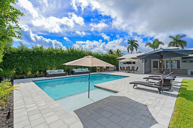outdoor pool with an outdoor living space, outdoor dining area, and a patio area