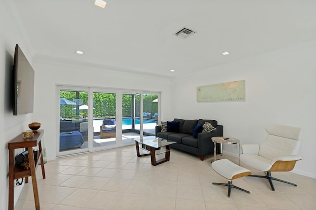 living room featuring light tile patterned floors, visible vents, and crown molding