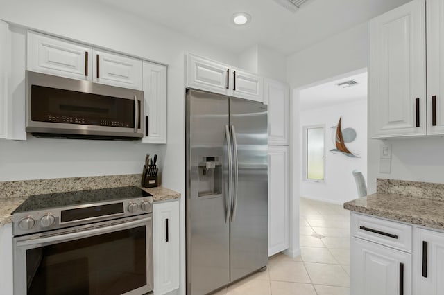 kitchen with visible vents, recessed lighting, stainless steel appliances, white cabinets, and light tile patterned flooring