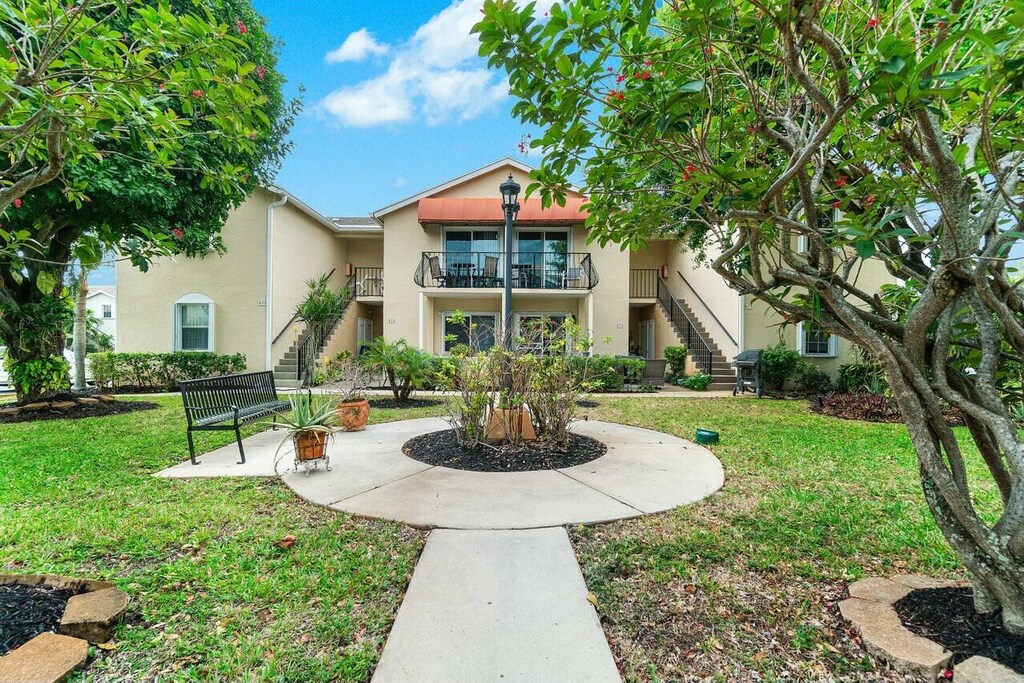 673 Waterside Dr, Hypoluxo, FL 33462 - view of property's community featuring stairs and a yard