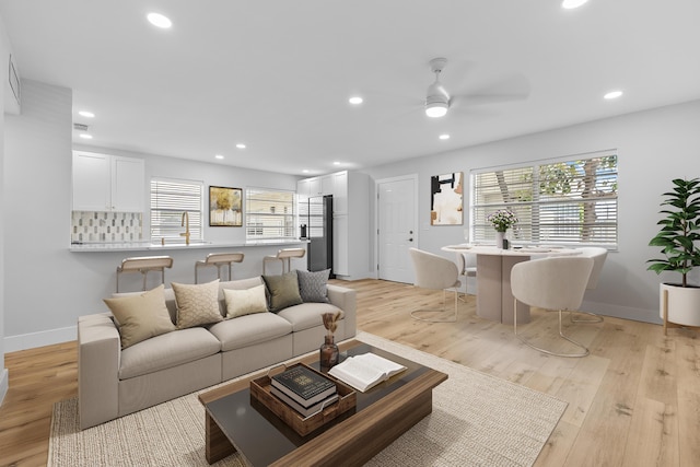 314 Monaco Unit G, Delray Beach, FL 33446 - kitchen featuring white cabinets, a sink, stainless steel microwave, tasteful backsplash, and visible vents