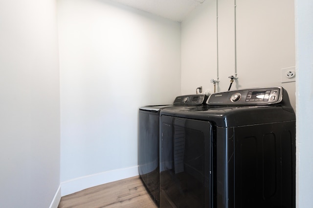 314 Monaco Unit G, Delray Beach, FL 33446 - clothes washing area featuring separate washer and dryer, baseboards, laundry area, and light wood-type flooring