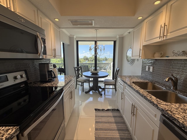 2003 N Ocean Blvd Unit 305N, Boca Raton, FL 33431 - kitchen featuring visible vents, appliances with stainless steel finishes, white cabinetry, and a sink
