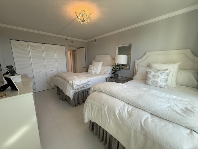 2003 N Ocean Blvd Unit 305N, Boca Raton, FL 33431 - bedroom with a closet, visible vents, light tile patterned flooring, and ornamental molding