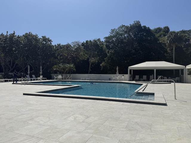 2003 N Ocean Blvd Unit 305N, Boca Raton, FL 33431 - pool featuring a patio area and fence