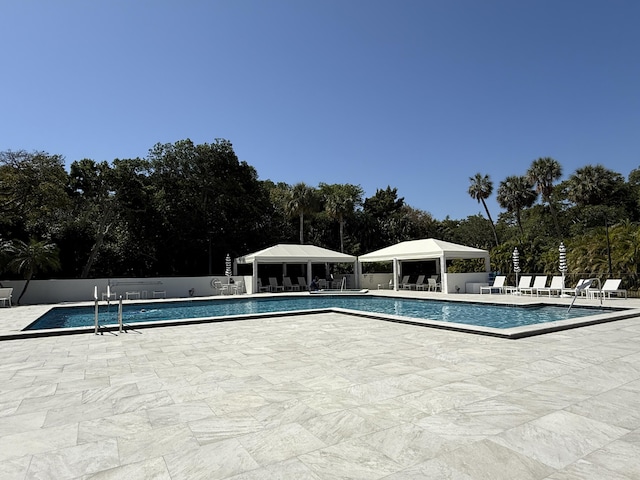 2003 N Ocean Blvd Unit 305N, Boca Raton, FL 33431 - community pool with a gazebo, fence, and a patio