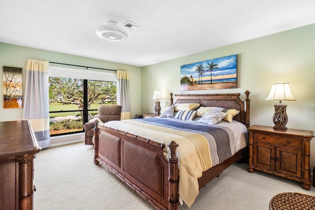 bedroom featuring light colored carpet and visible vents