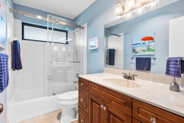 bathroom with toilet,  shower combination, vanity, and tile patterned flooring