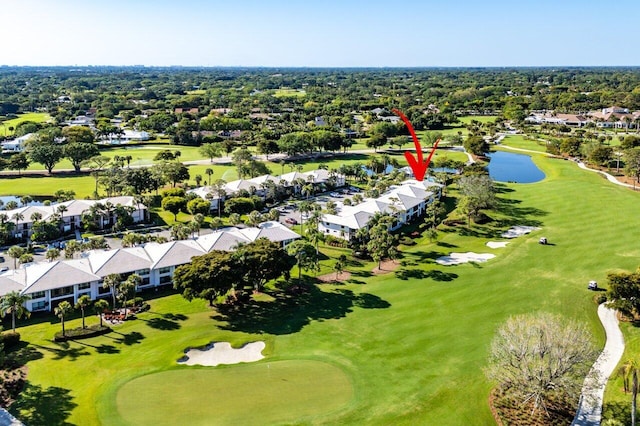 drone / aerial view with golf course view, a water view, and a residential view