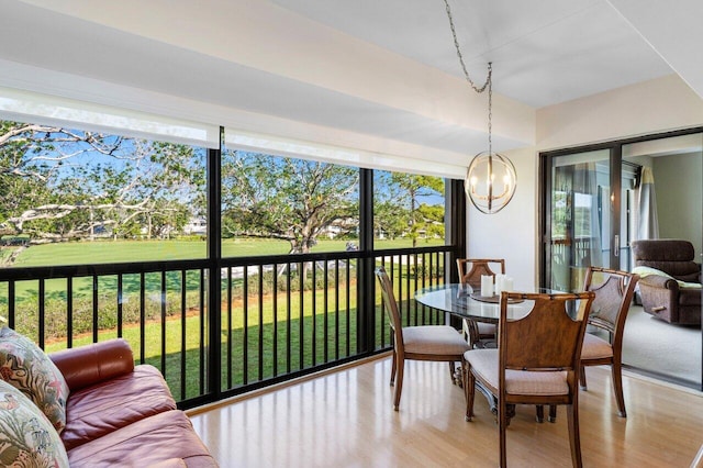 sunroom featuring a notable chandelier
