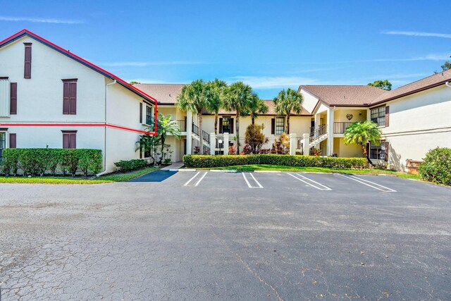 3251 Perimeter Dr, Greenacres, FL 33467 - view of property featuring uncovered parking