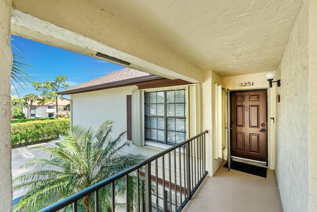 3251 Perimeter Dr, Greenacres, FL 33467 - property entrance featuring a balcony and stucco siding