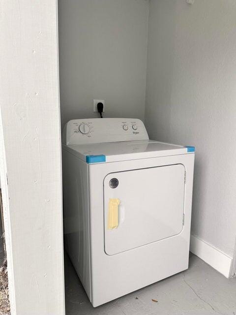 washroom with laundry area, washer / clothes dryer, and baseboards