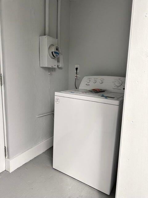 washroom with washer / dryer and baseboards