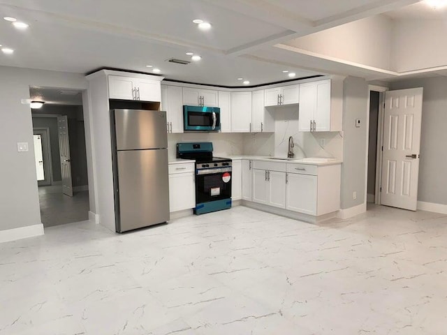 kitchen with marble finish floor, a sink, tasteful backsplash, appliances with stainless steel finishes, and light countertops