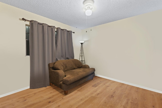 7003 Arthurs Rd, Fort Pierce, FL 34951 - living area featuring baseboards, a textured ceiling, and light wood-style flooring