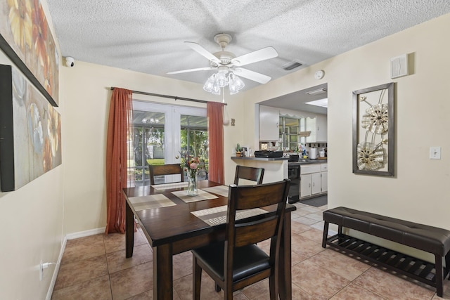 7003 Arthurs Rd, Fort Pierce, FL 34951 - dining area featuring visible vents, baseboards, ceiling fan, light tile patterned flooring, and a textured ceiling