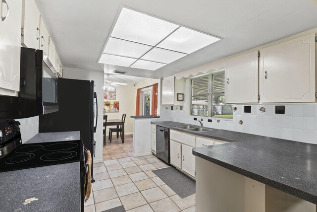 7003 Arthurs Rd, Fort Pierce, FL 34951 - kitchen with black appliances, a sink, tasteful backsplash, dark countertops, and light tile patterned floors