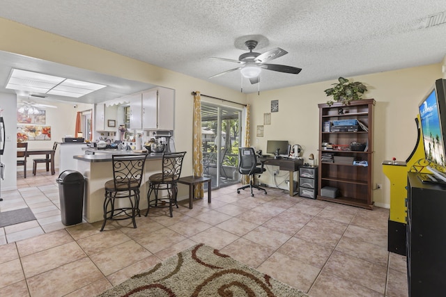 7003 Arthurs Rd, Fort Pierce, FL 34951 - home office with a textured ceiling, light tile patterned flooring, visible vents, and ceiling fan