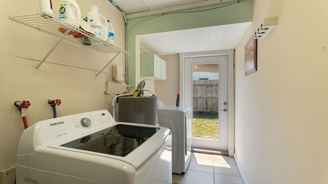 4142 NE Robin Ct, Jensen Beach, FL 34957 - laundry room featuring water heater, separate washer and dryer, and tile patterned floors