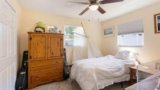 4142 NE Robin Ct, Jensen Beach, FL 34957 - bedroom with light colored carpet and ceiling fan