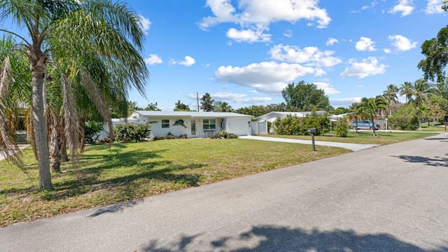 4142 NE Robin Ct, Jensen Beach, FL 34957 - ranch-style house with concrete driveway and a garage