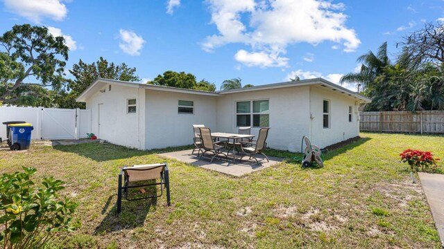 4142 NE Robin Ct, Jensen Beach, FL 34957 - rear view of property featuring a gate, a fenced backyard, a patio area, and stucco siding