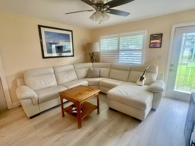 4142 NE Robin Ct, Jensen Beach, FL 34957 - living room featuring healthy amount of natural light, light wood finished floors, and a ceiling fan
