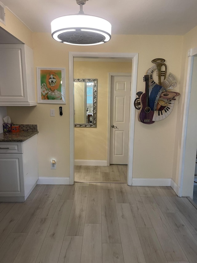 4142 NE Robin Ct, Jensen Beach, FL 34957 - hallway with light wood-style flooring and baseboards