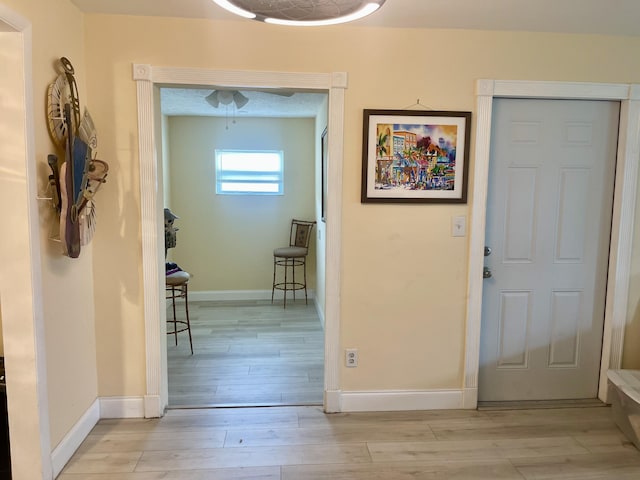 4142 NE Robin Ct, Jensen Beach, FL 34957 - foyer entrance featuring light wood-style flooring and baseboards
