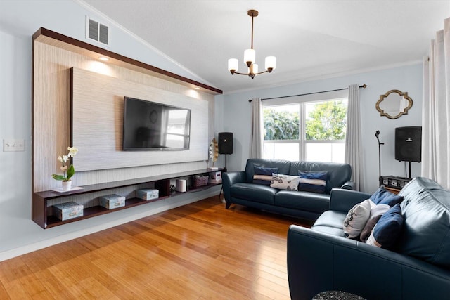 living area with visible vents, lofted ceiling, light wood-style floors, crown molding, and a notable chandelier