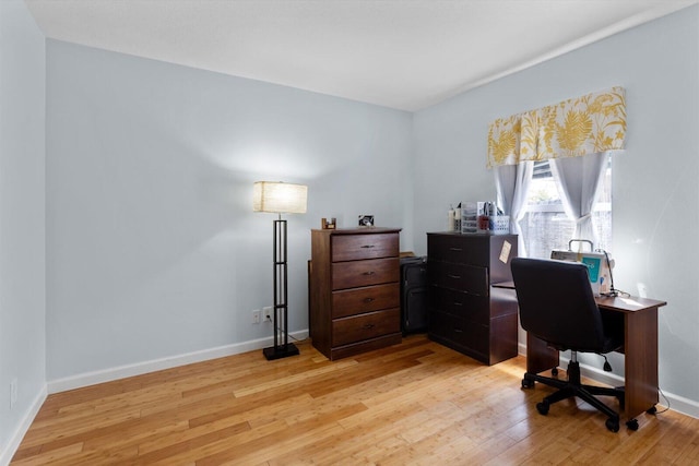 home office with light wood finished floors and baseboards