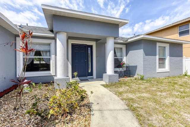 view of exterior entry with stucco siding