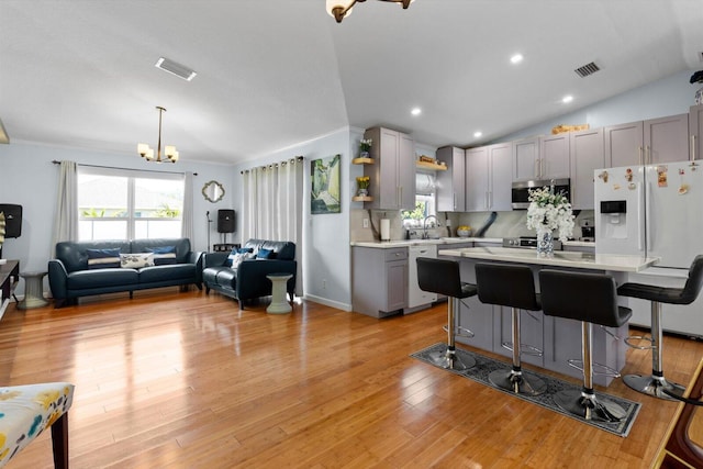 kitchen with a notable chandelier, visible vents, white appliances, and light countertops