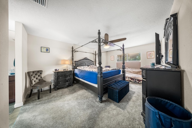 carpeted bedroom with visible vents, baseboards, a textured ceiling, and a ceiling fan
