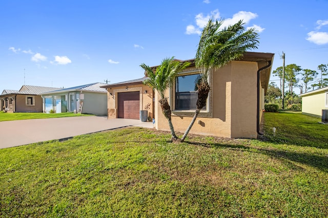 single story home featuring a front lawn, central air condition unit, concrete driveway, stucco siding, and a garage