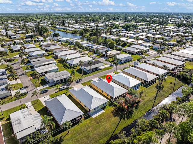 birds eye view of property featuring a residential view and a water view