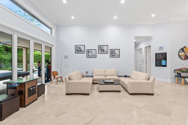 living area with recessed lighting, baseboards, a high ceiling, and crown molding
