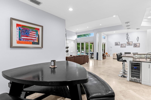 dining room featuring visible vents, ornamental molding, recessed lighting, wine cooler, and wet bar