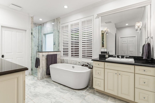 full bath featuring marble finish floor, ornamental molding, a shower stall, a freestanding bath, and vanity