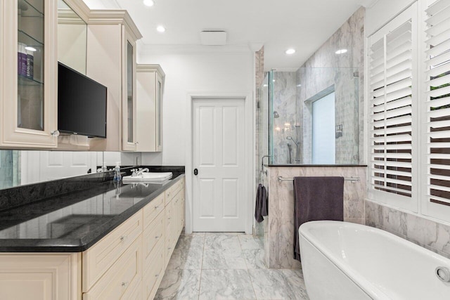 bathroom with vanity, a soaking tub, a stall shower, ornamental molding, and marble finish floor