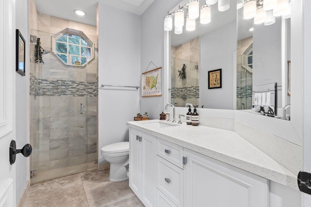bathroom with vanity, toilet, and a stall shower