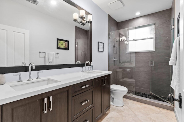 full bath featuring tile patterned flooring, toilet, a stall shower, and a sink