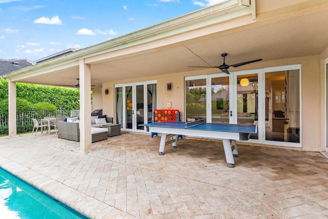 view of patio featuring an outdoor living space, french doors, ceiling fan, and fence