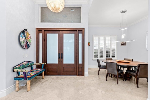 foyer entrance with french doors, crown molding, and baseboards