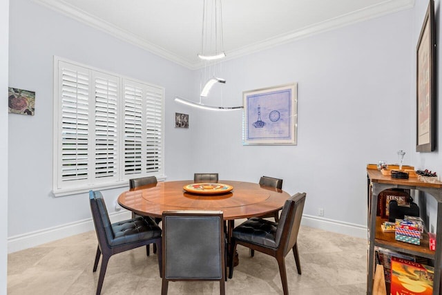 dining area with crown molding and baseboards