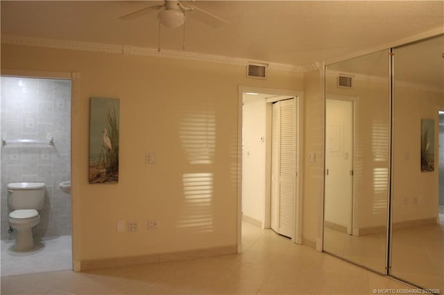 unfurnished bedroom featuring visible vents, ensuite bath, ornamental molding, and light tile patterned flooring