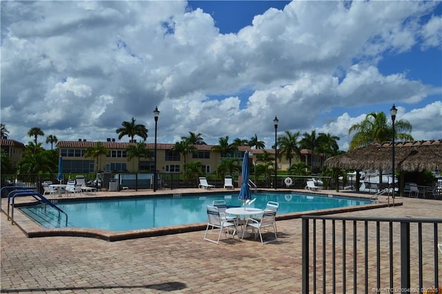 pool featuring a patio and fence