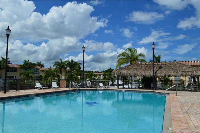 pool featuring a patio and fence